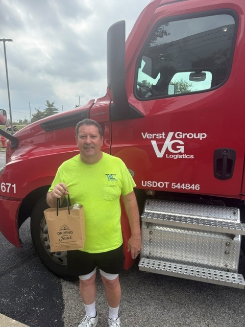 A Verst Logistics truck driver with his Driving With Jesus care bag