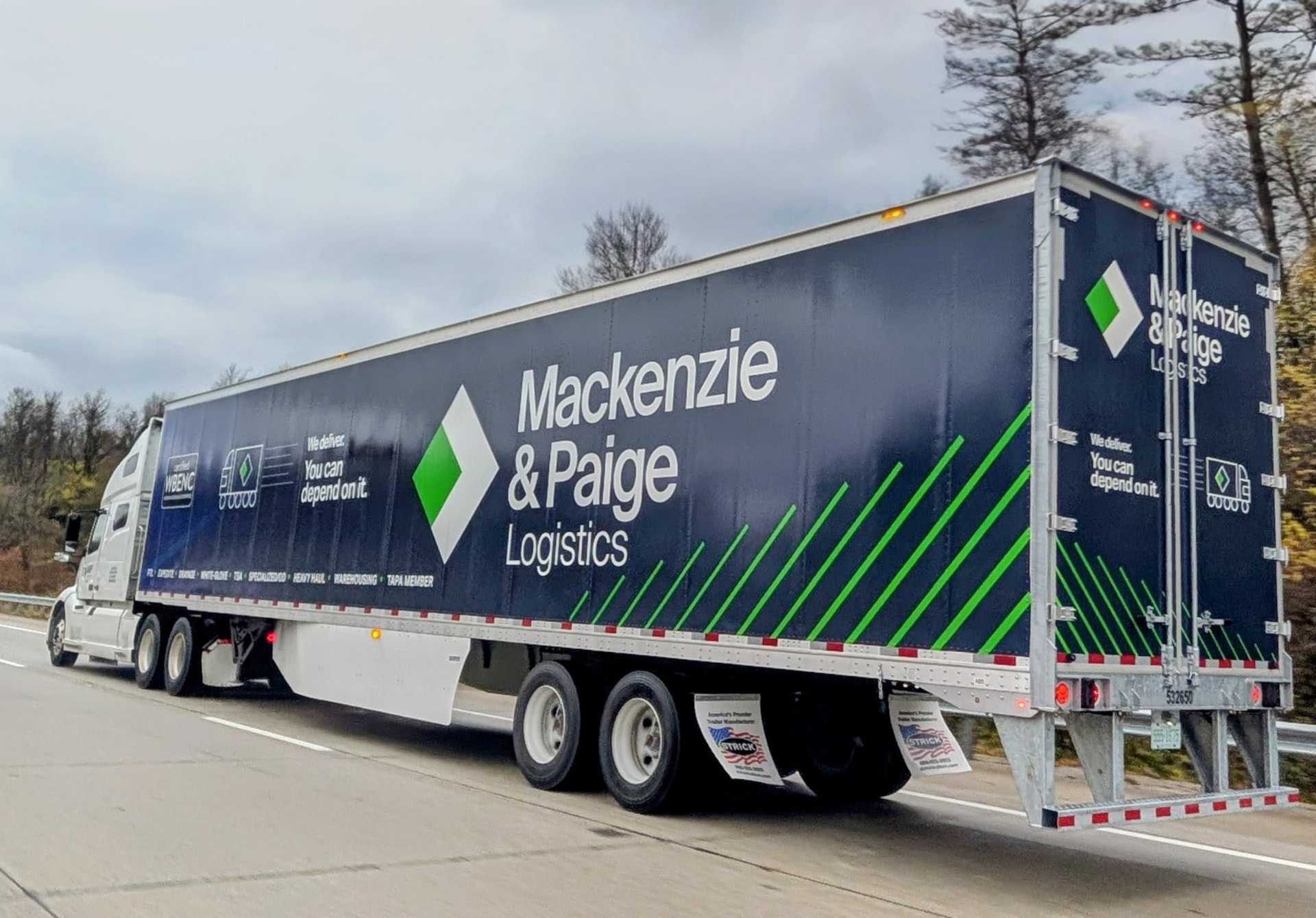 Mackenzie and Paige Logistics truck traveling on the road